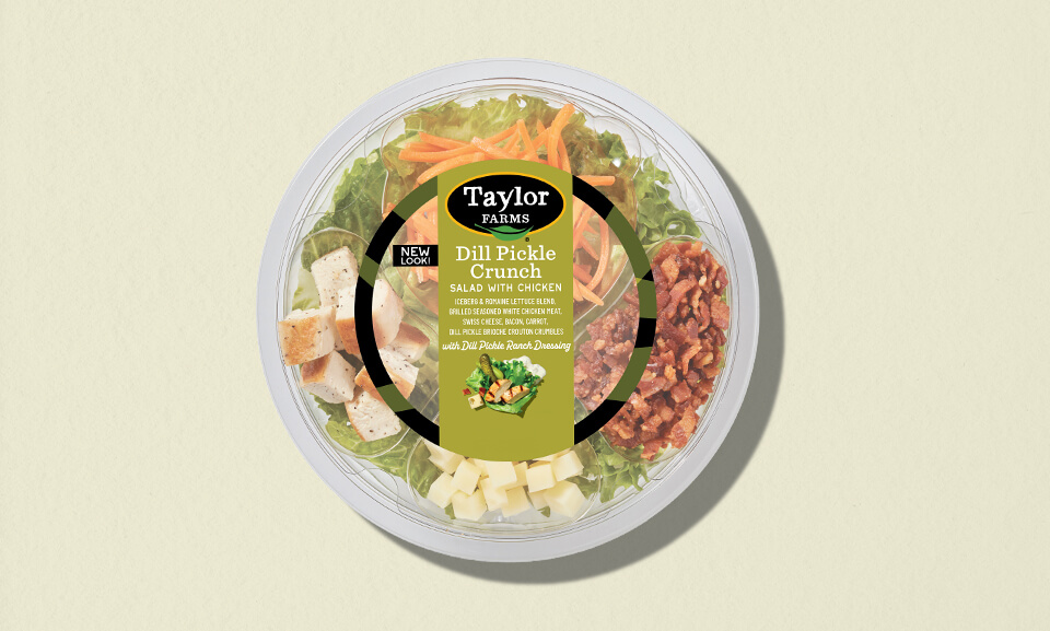 Dill pickle crunch single-serve bowls showcasing vibrant packaging on a colorful background.