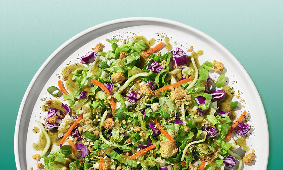 Fresh Green Goddess Chopped Salad Kit featuring vibrant greens, crunchy toppings, and creamy dressing.