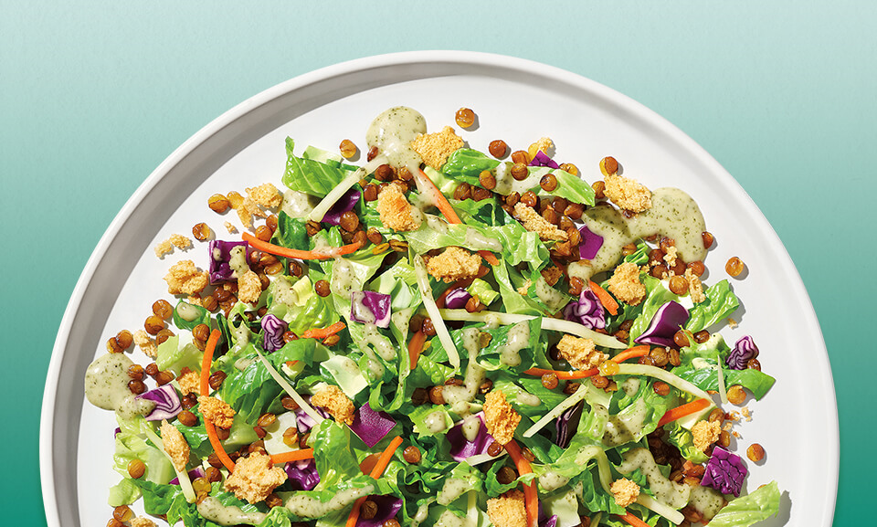 Chopped salad kit featuring Green Goddess dressing with fresh greens and colorful toppings from Taylor Farms.