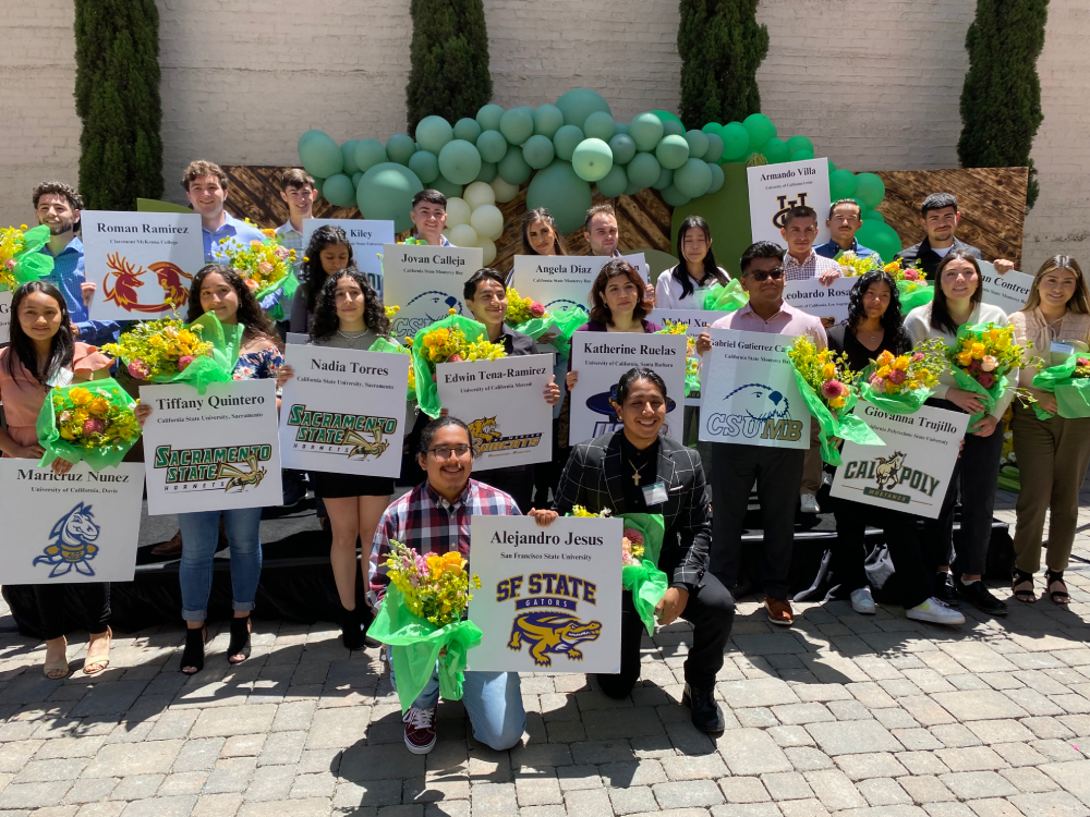 students holding signs with their names and schools at the Taylor Farms scholarship program