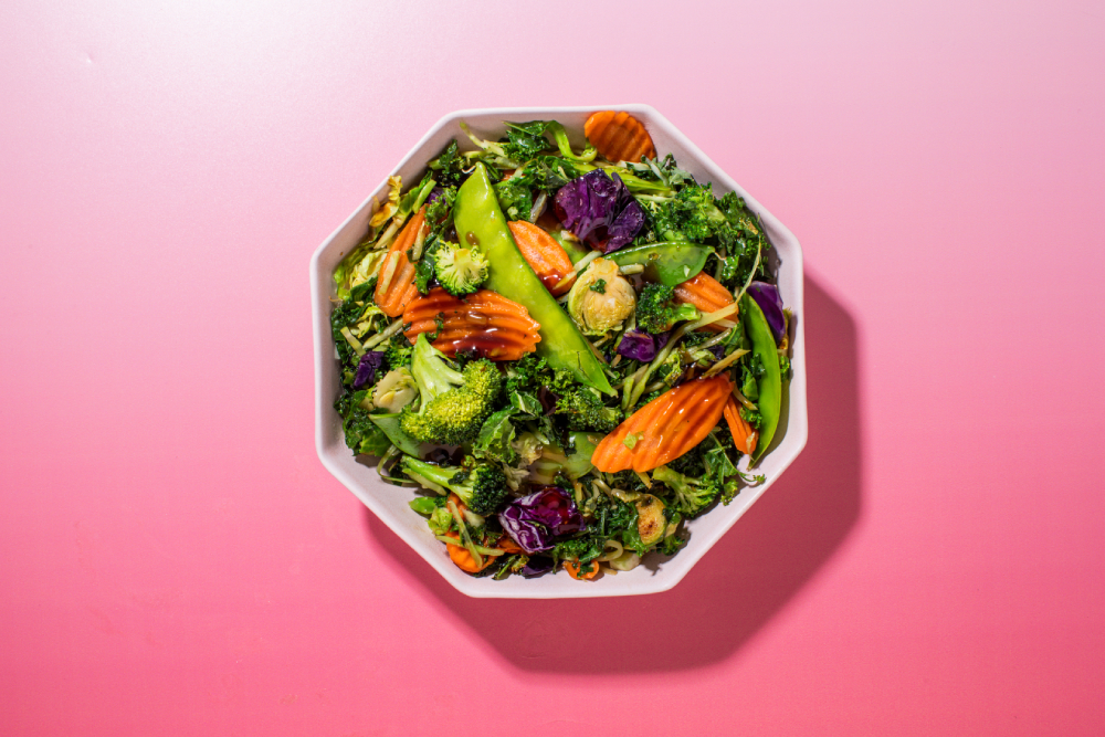 Taylor Farms teriyaki meal kit in a bowl on a pink background