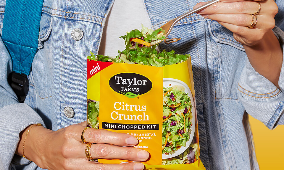Citrus Crunch Mini Chopped Salad Kit featuring vibrant yellow ingredients and fresh vegetables in a lifestyle setting.