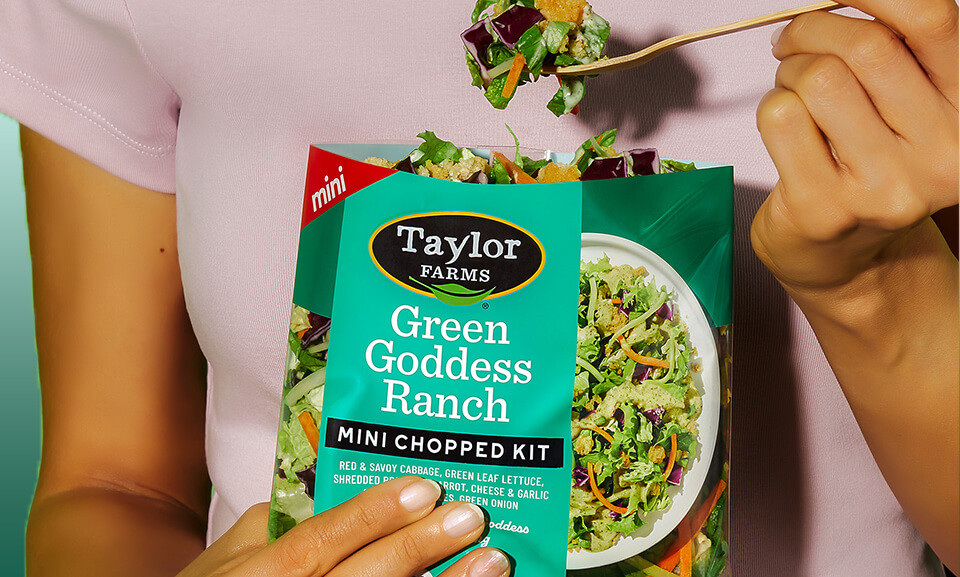 Fresh Green Goddess Mini Chopped Salad Kit with vibrant greens and dressing showcased in a lifestyle setting.