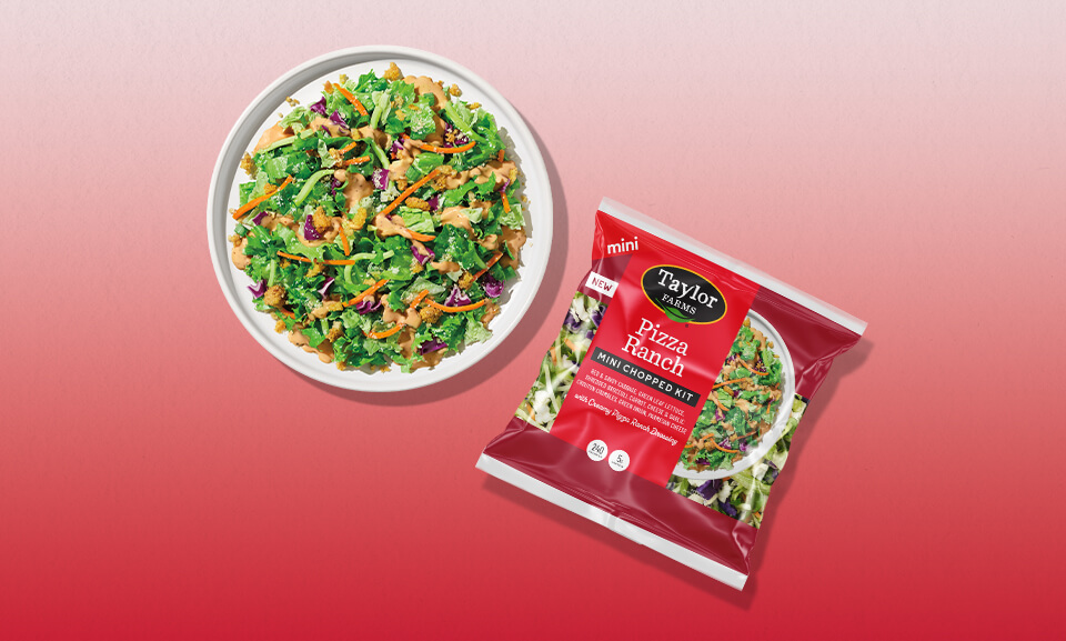 Mini Chopped Salad Kit on a red plate, featuring fresh greens and vibrant toppings, perfect for quick meals.