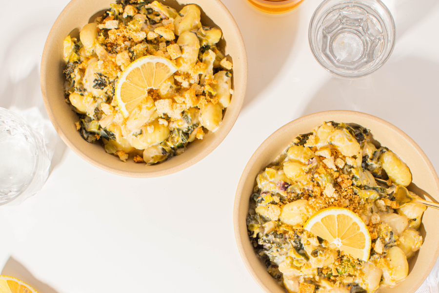 Two bowls of Taylor Farms Asiago Kale Gnocchi on a table