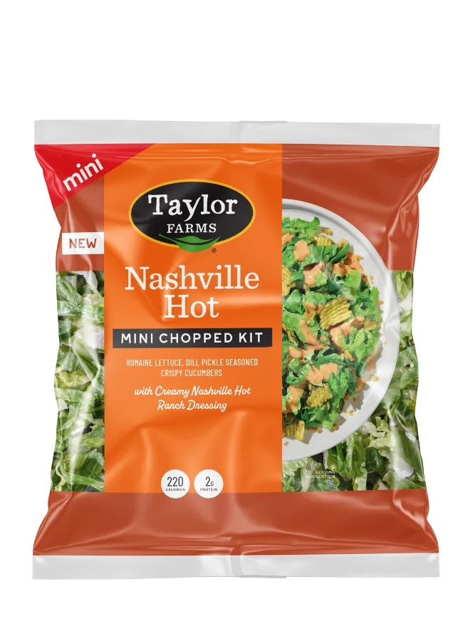 The Taylor Farms Nashville Hot Mini Chopped Salad Kit package, showing chopped romaine lettuce, dill pickle-seasoned crispy cucumbers, and creamy Nashville Hot ranch dressing.