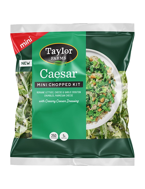 Taylor Farms Caesar mini chopped salad kit featuring romaine lettuce, parmesan cheese, croutons, and Caesar dressing.