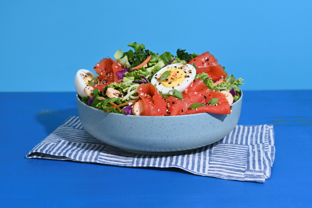 Taylor Farms Everything Lox Salad in a bowl with a blue background