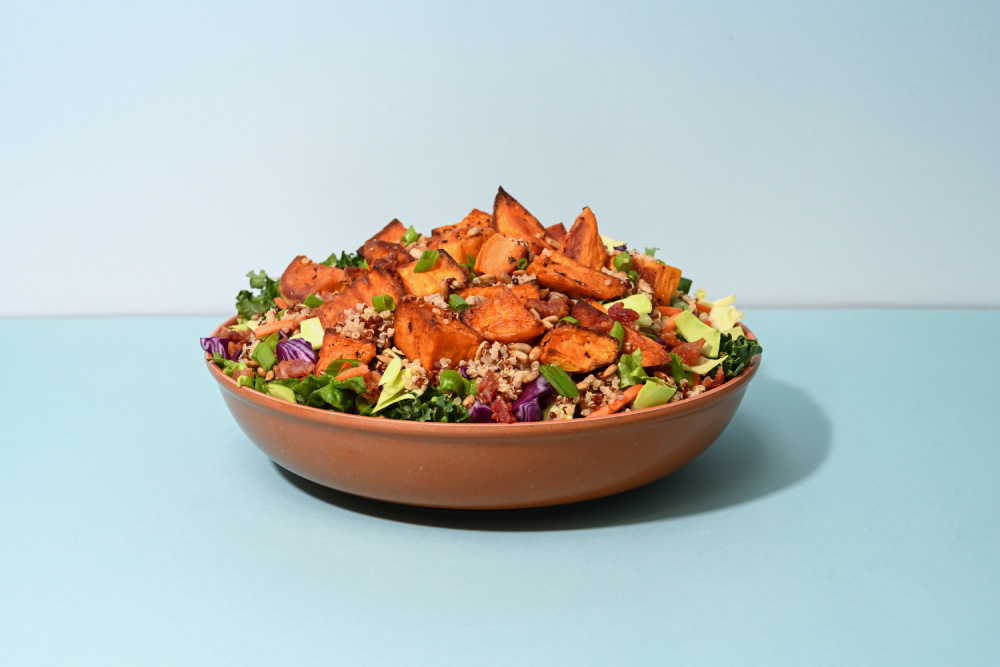Taylor Farms Sunflower Crunch Grain Salad in a bowl with a blue background