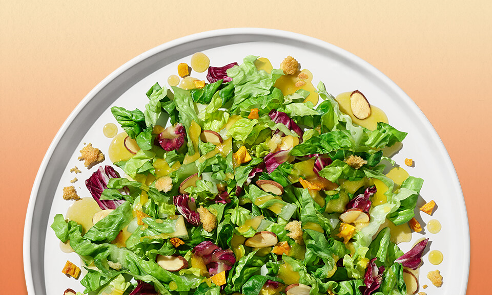 Fresh mango lemonade chopped salad kit with vibrant greens, mango, and lemon slices, perfect for a refreshing meal.