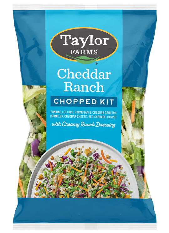 The Taylor Farms Cheddar Ranch Chopped Salad Kit package, showing chopped romaine, parmesan & cheddar-dusted crouton crumbles, red cabbage, carrot, cheddar cheese, and ranch dressing.