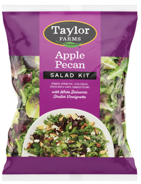 The Taylor Farms Apple Pecan Chopped Salad Kit package, showing spring mix, feta cheese, crispy apple chips, candied pecans, and the white shallot balsamic vinaigrette.