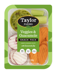 The Taylor Farms Veggies and Guacamole Snack Pack package, showing celery sticks, carrot chips, radish chips, and guacamole.