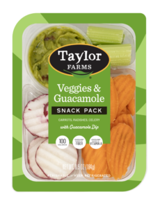 The Taylor Farms Veggies and Guacamole Snack Pack package, showing celery sticks, carrot chips, radish chips, and guacamole.