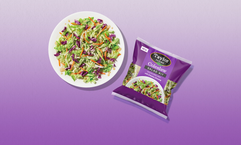 Fresh coleslaw salad kit served on a plate, featuring colorful vegetables for a delicious and healthy meal option.