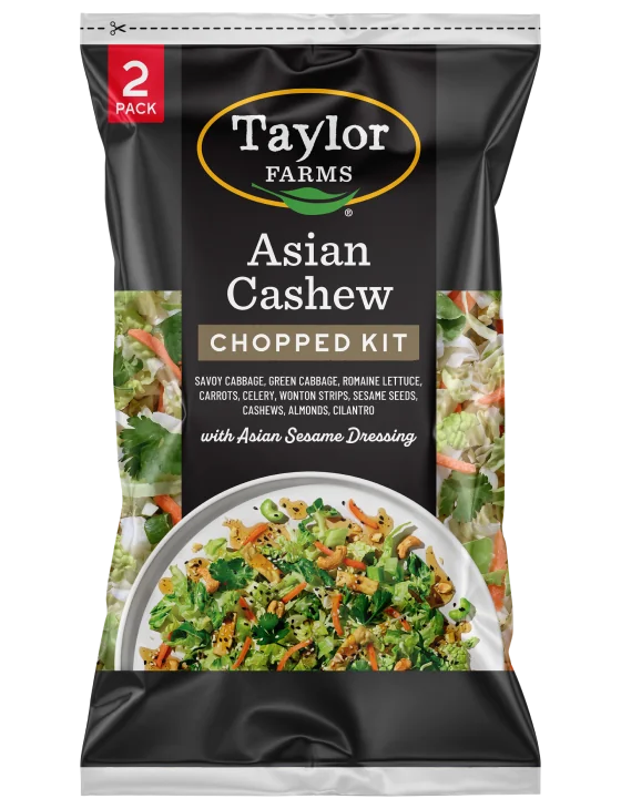 The Taylor Farms Asian Cashew Chopped Salad Kit package, showing cabbage, green cabbage, romaine, carrots, celery, wonton strips, sesame seeds, cashews, almonds, cilantro, and Asian sesame dressing.