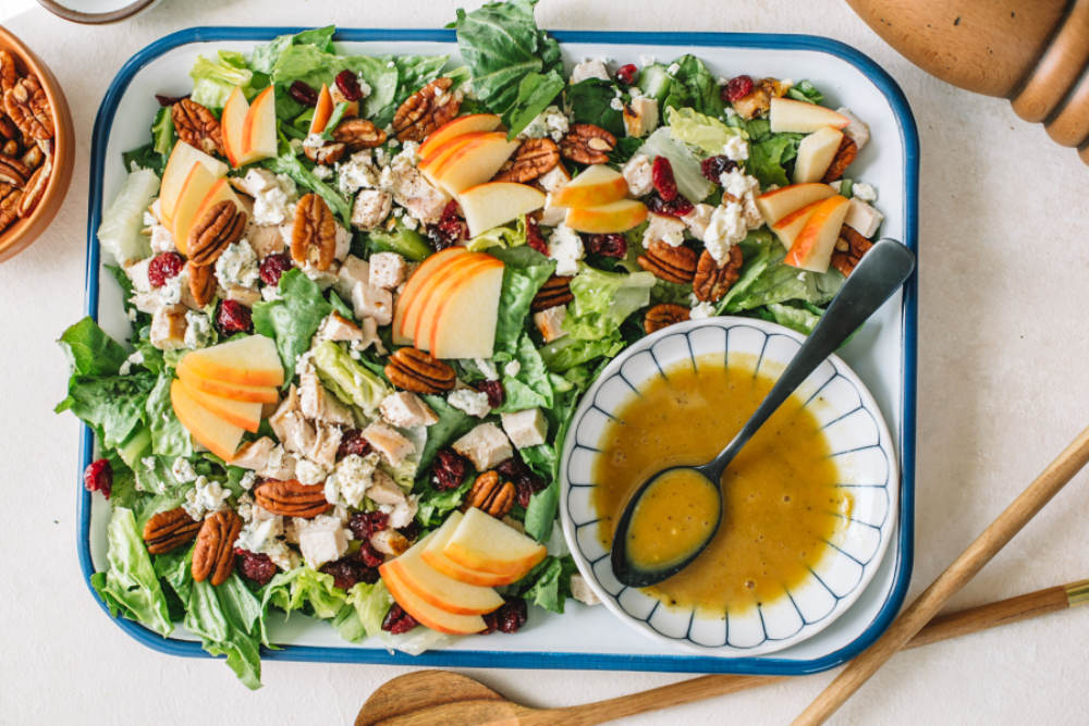 Pecan chicken salad with romaine lettuce and apple, featuring fresh ingredients for a nutritious meal.