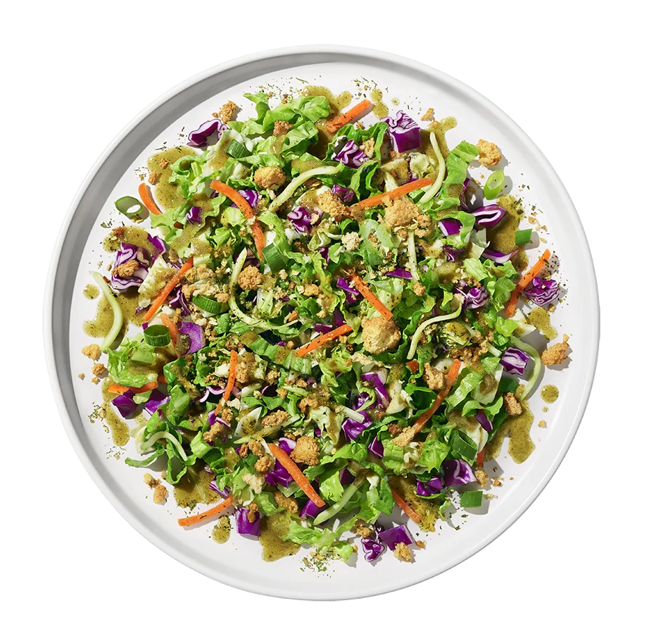 Colorful gourmet salad mix with fresh greens, cherry tomatoes, and crunchy toppings arranged in a bowl.