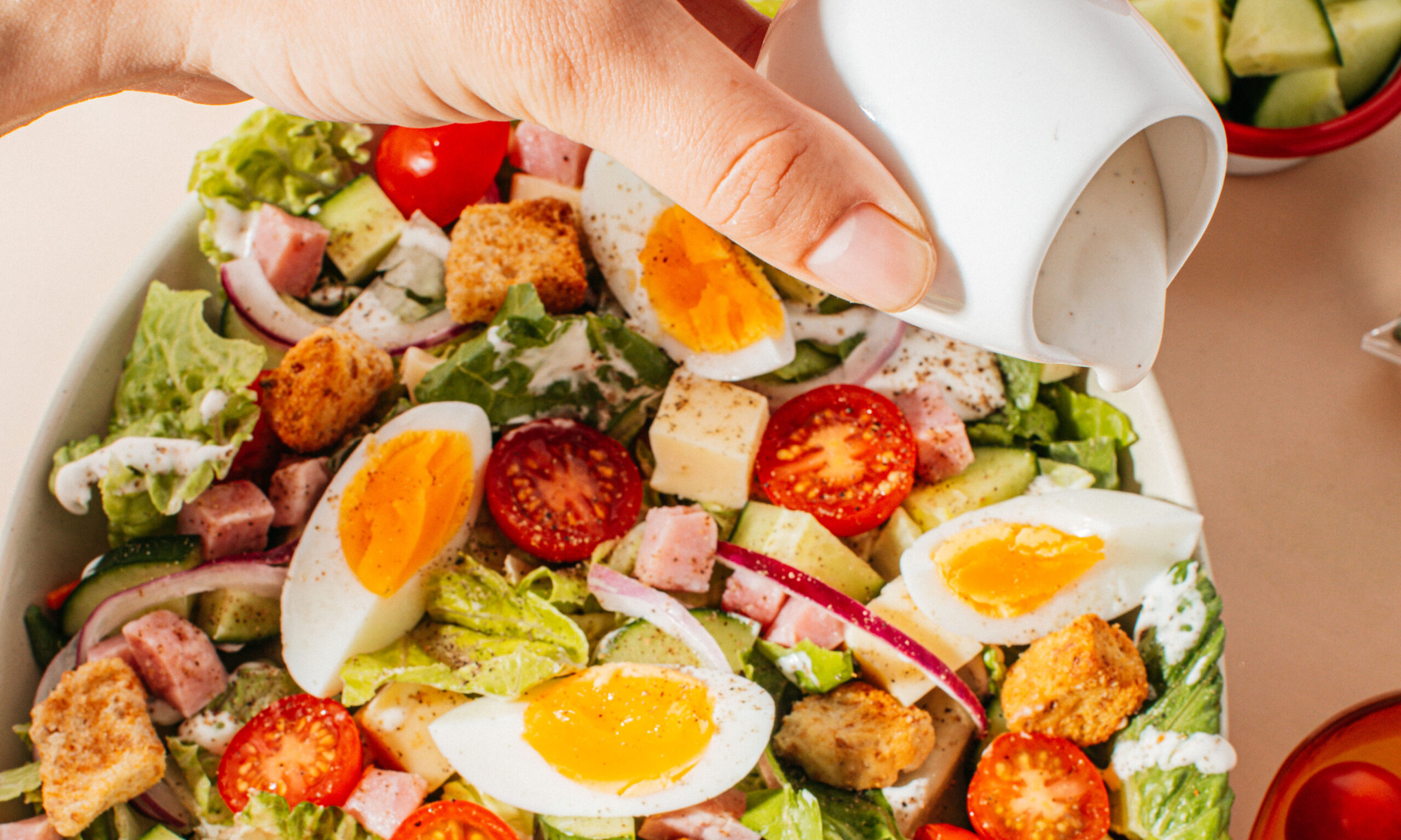 Colorful fresh salad with mixed greens, cherry tomatoes, and cucumbers from Taylor Farms. Perfect for summer meals.