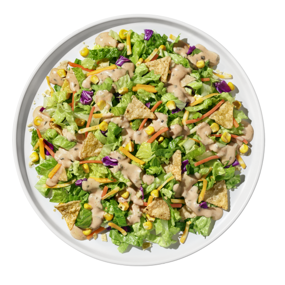 Chipotle ranch salad plated with fresh greens and colorful vegetables from Taylor Farms.