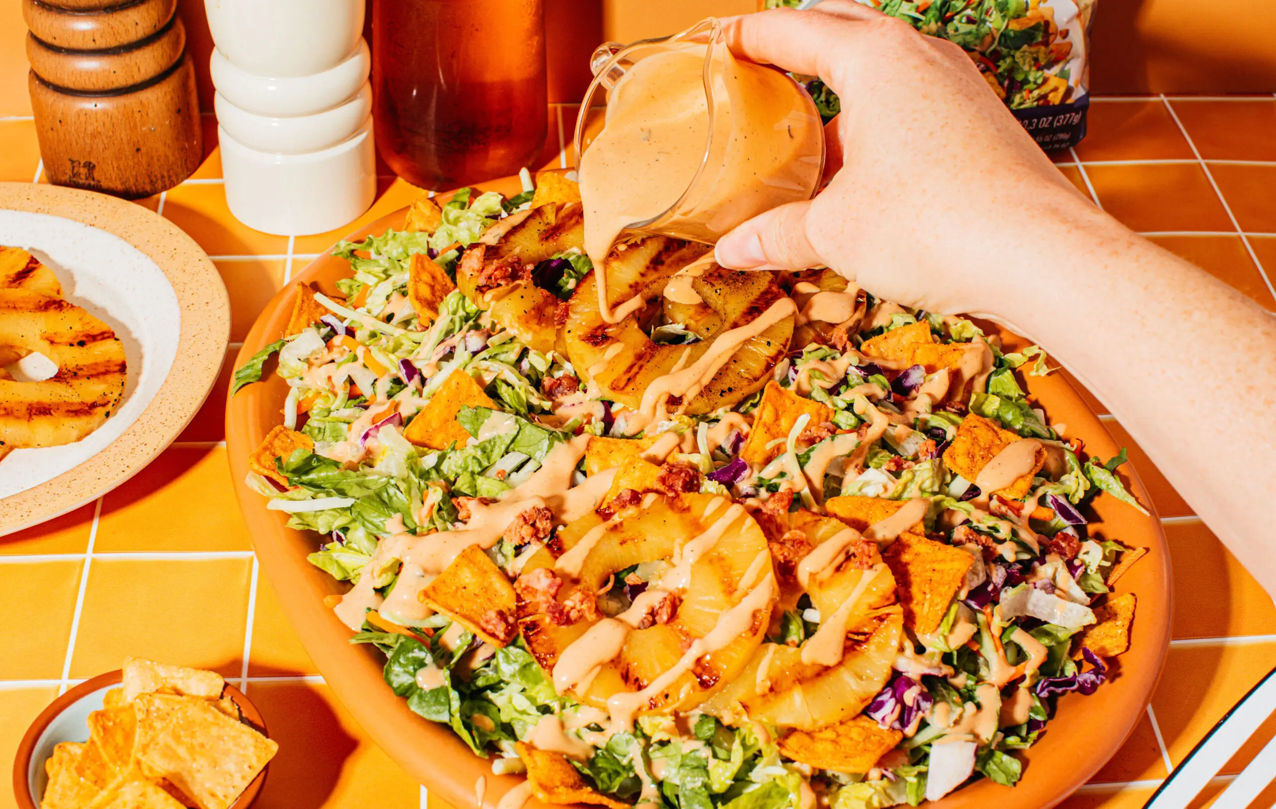 Freshly harvested greens and colorful vegetables in a sunny outdoor farm setting by Taylor Farms.