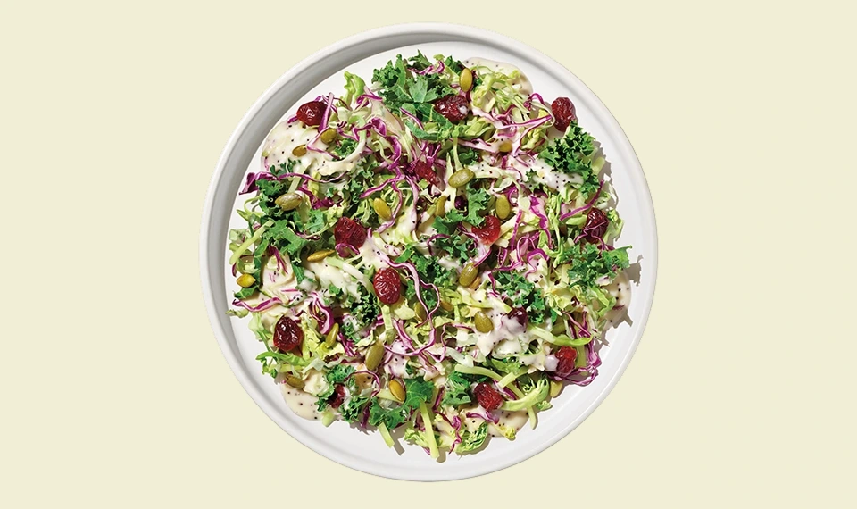 Fresh Sweet Kale salad mix with vibrant greens and toppings for healthy meals.