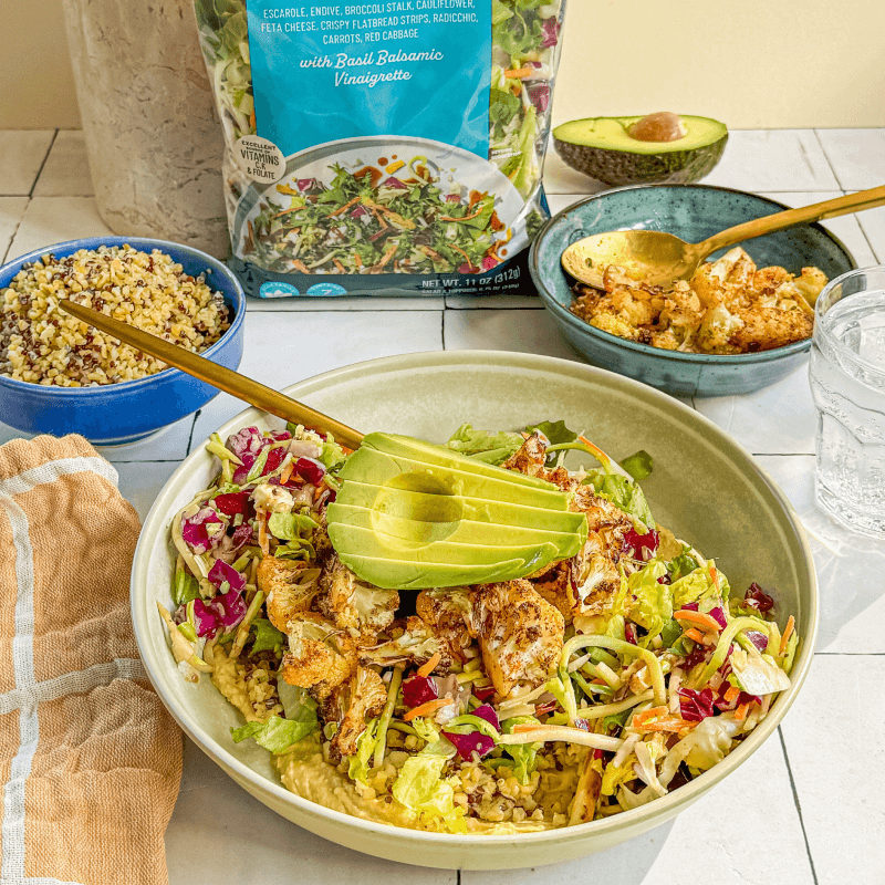 Mediterranean bowl featuring fresh vegetables, grains, and olives inspired by Blue Zones cuisine.